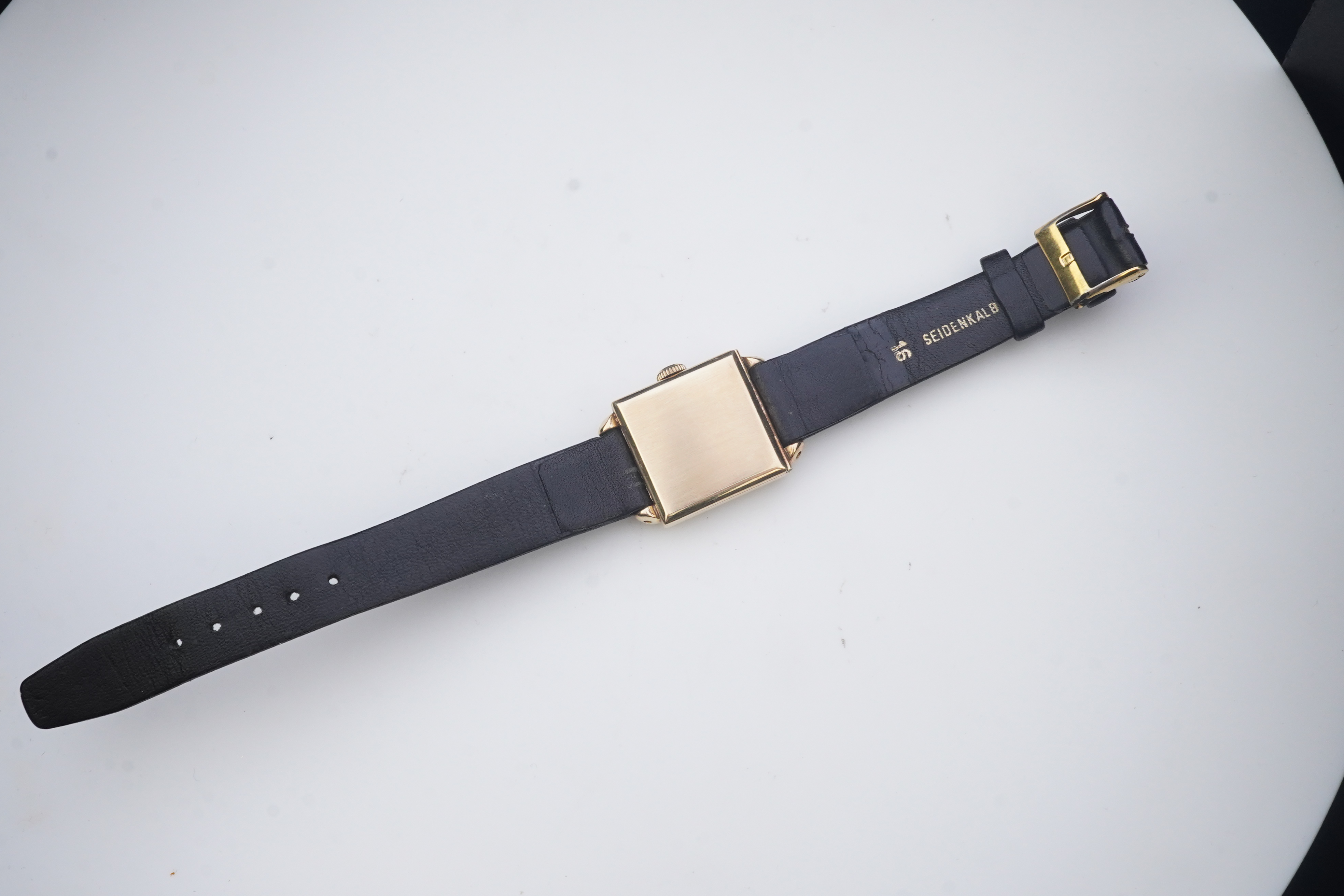 A gentleman's mid 20th century 14k gold International Watch Company manual wind wrist watch, on a later associated leather strap